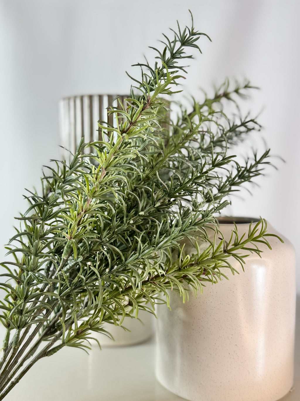 Artificial Bloom artificial rosemary botanical stem with realistic green needle-like leaves in a decorative vase