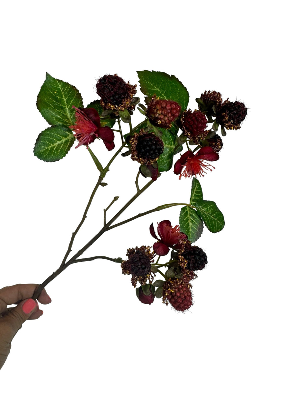 Artificial Bloom decorative blackberry stem with dark berries, red blossoms, and green leaves held by a hand