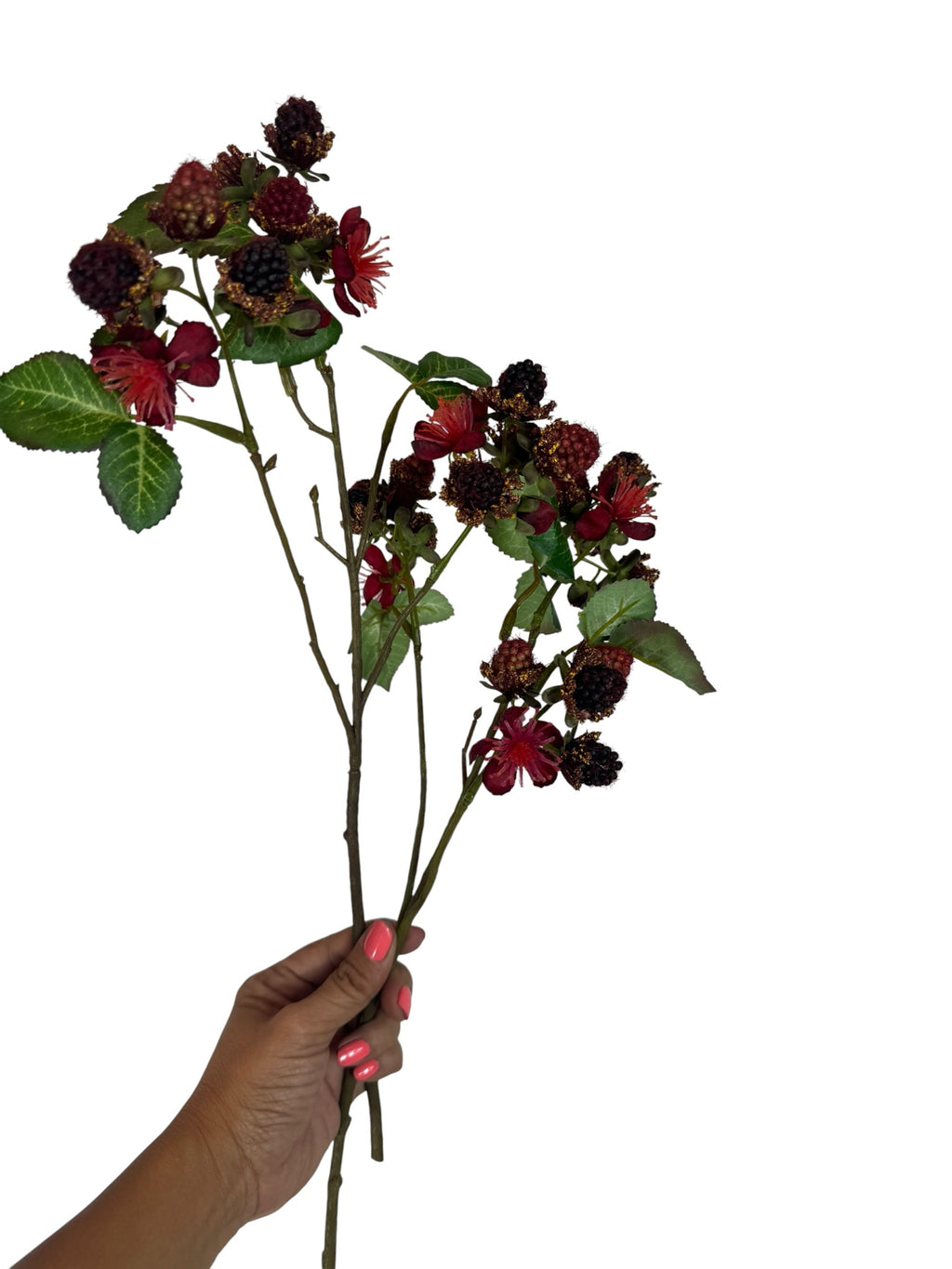 Artificial Bloom decorative blackberry stem with dark berries, red blossoms, and green leaves held in a hand