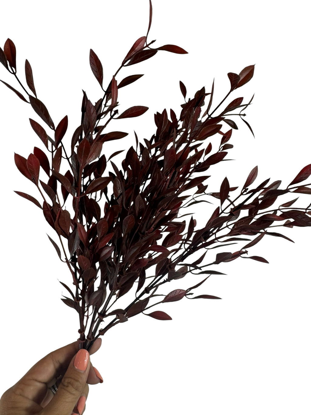 Artificial Bloom deep burgundy faux leafy branch stem held in hand, featuring realistic dark red foliage for home decor.