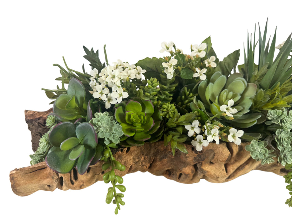 Artificial Bloom artificial succulent arrangement with white flowers in a rustic driftwood-style base for home decor.