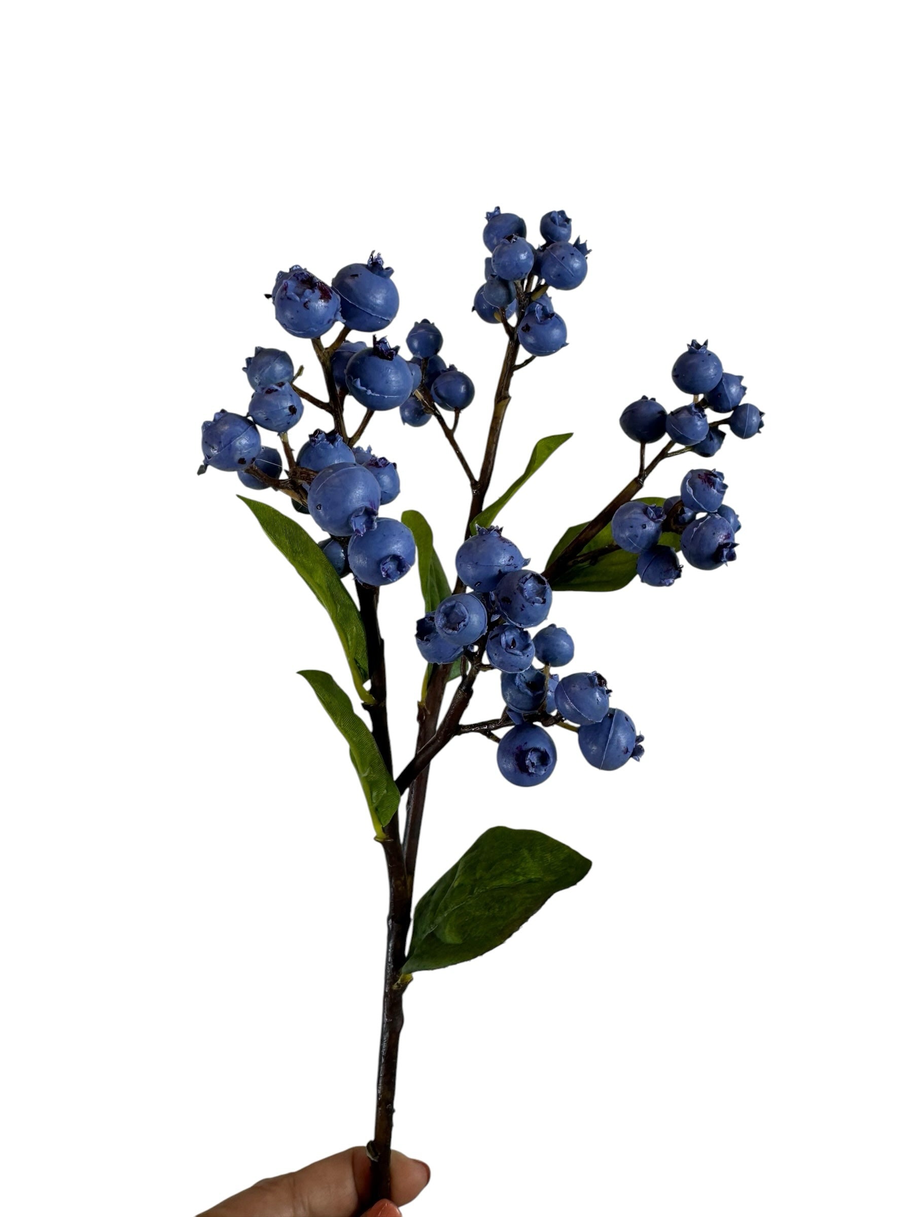 Artificial Bloom decorative faux blueberry stem with realistic deep blue berries and green leaves on a brown branch.