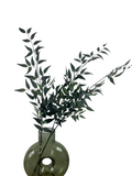 Artificial Bloom decorative faux eucalyptus stem with deep green lifelike leaves in a round green glass vase