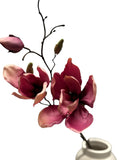 Artificial Bloom magenta and pink velvet magnolia floral stem with buds in a white ceramic vase