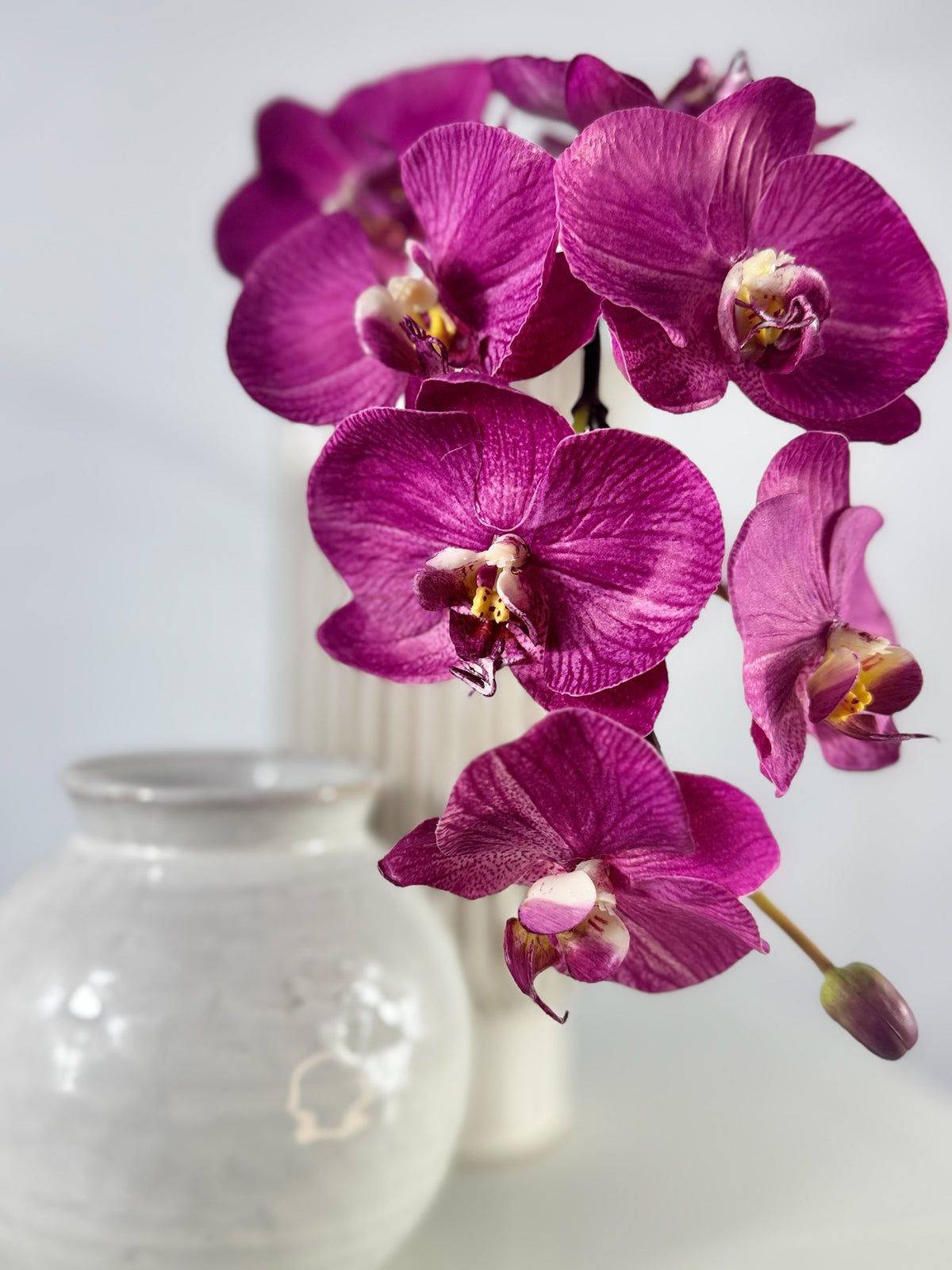 Artificial Bloom magenta Phalaenopsis orchid arrangement with realistic silk petals in a white ceramic vase