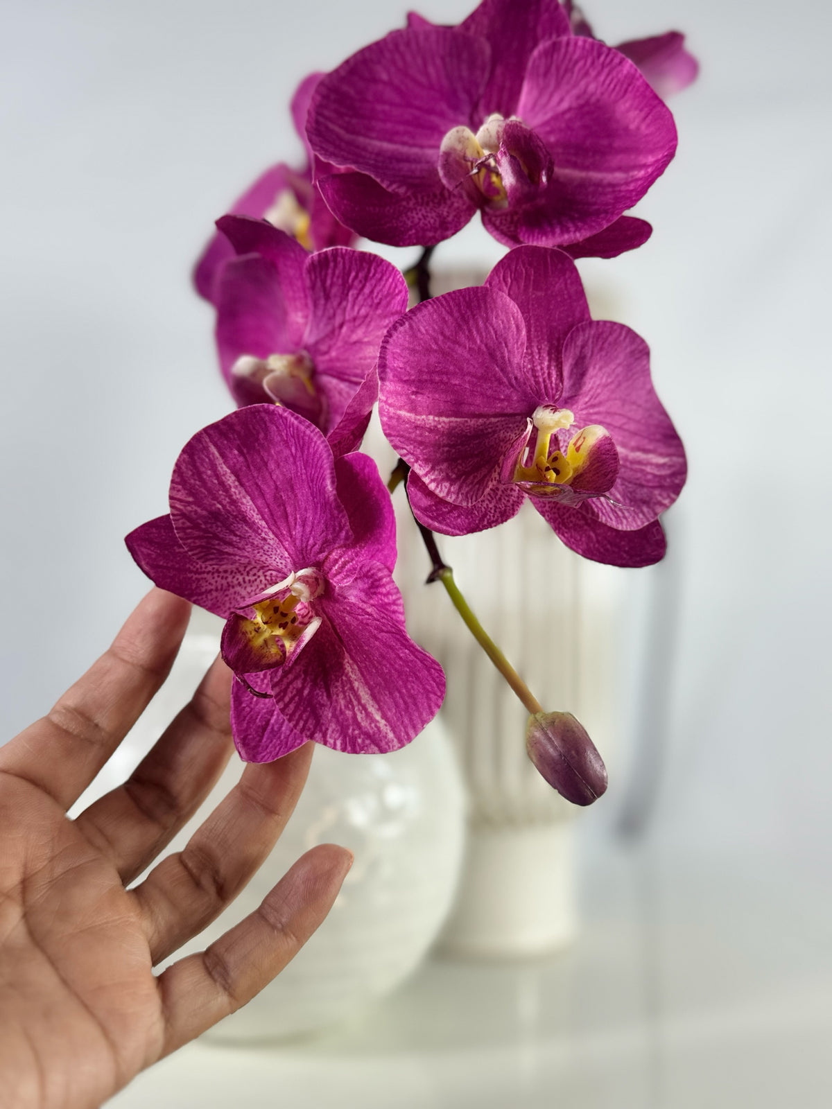 Artificial Bloom magenta Phalaenopsis orchid arrangement with realistic silk-feel petals in a white textured vase