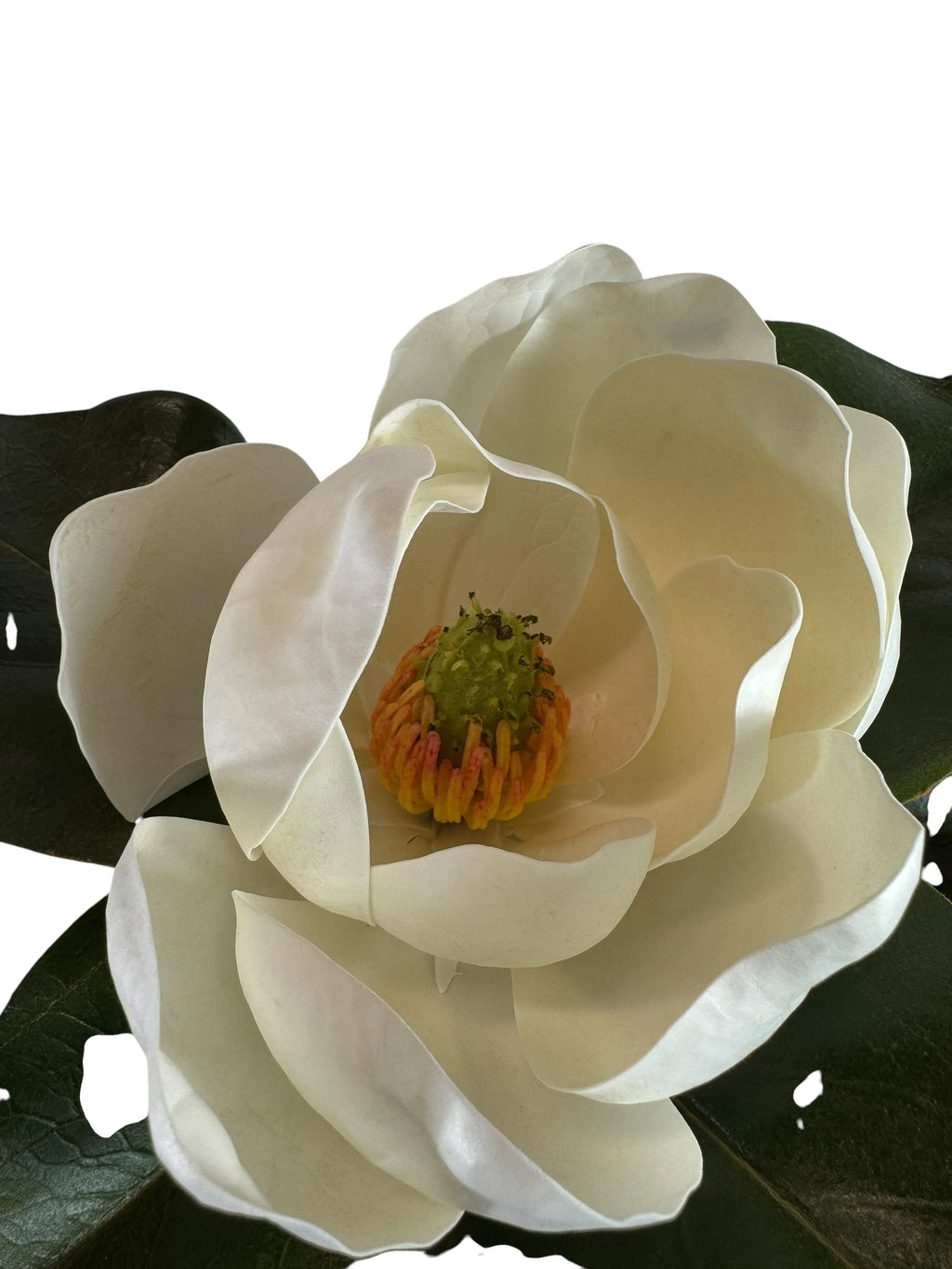 Artificial Bloom artificial magnolia flower stem with creamy white petals and detailed center, set against green leaves.