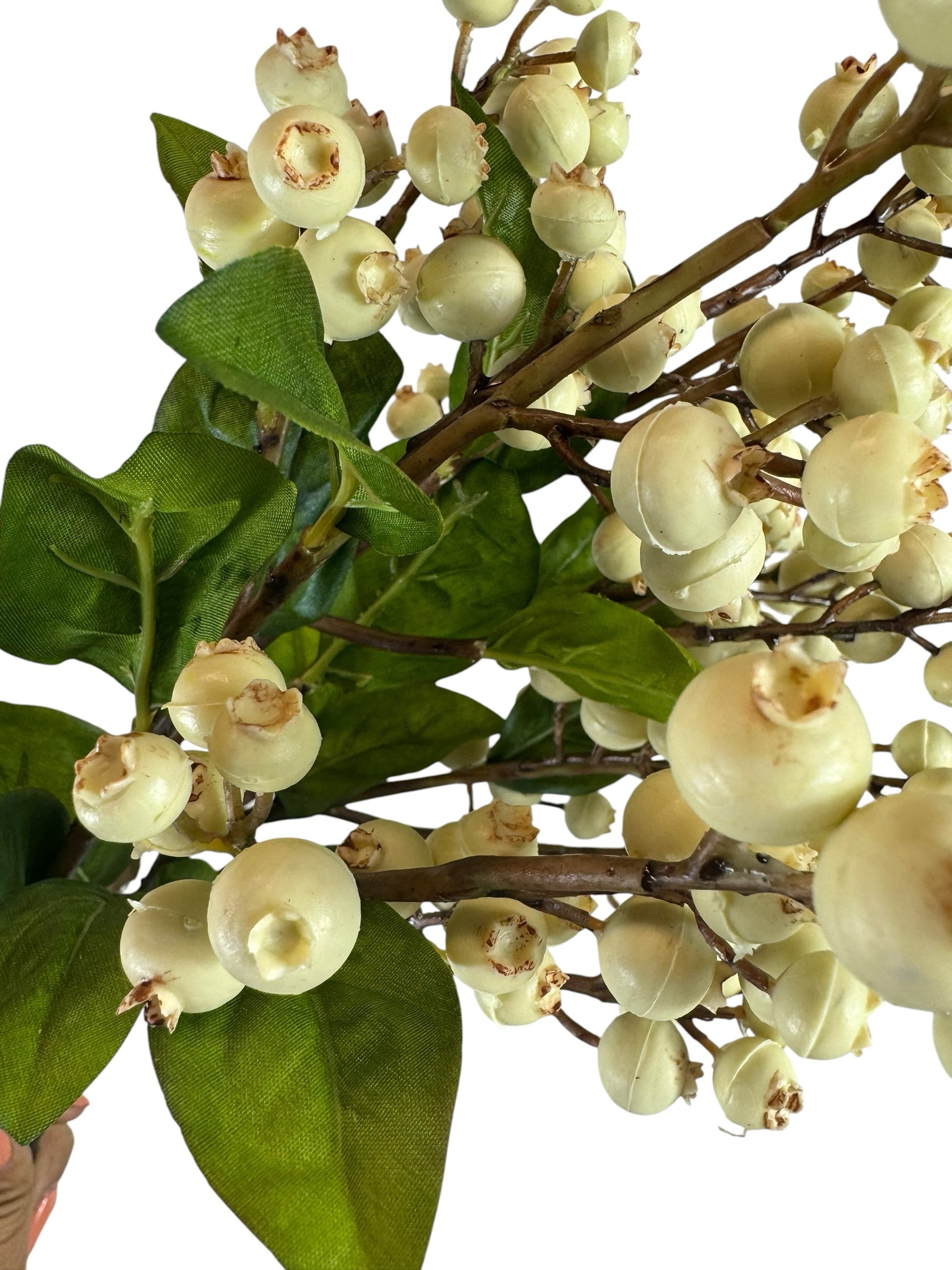 Artificial Bloom decorative floral stem featuring realistic creamy off-white berries and deep green leaves on branches