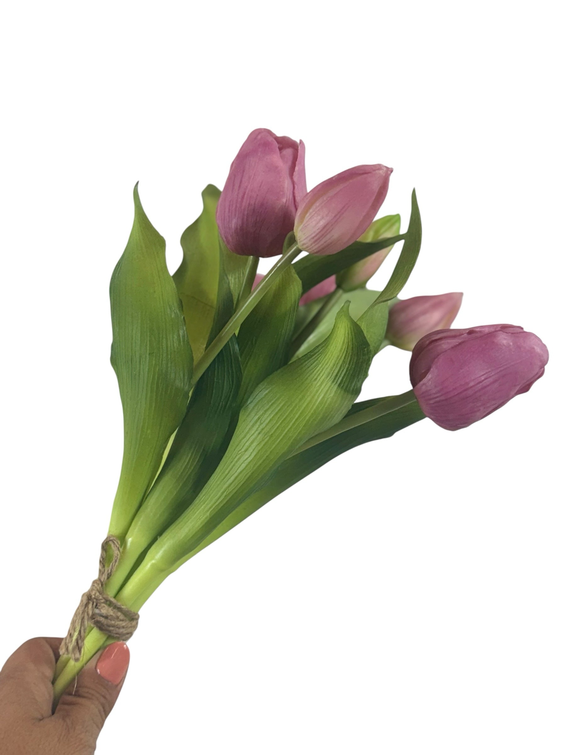 Artificial Bloom bouquet of realistic pink tulips with green foliage tied with rustic twine held by a hand