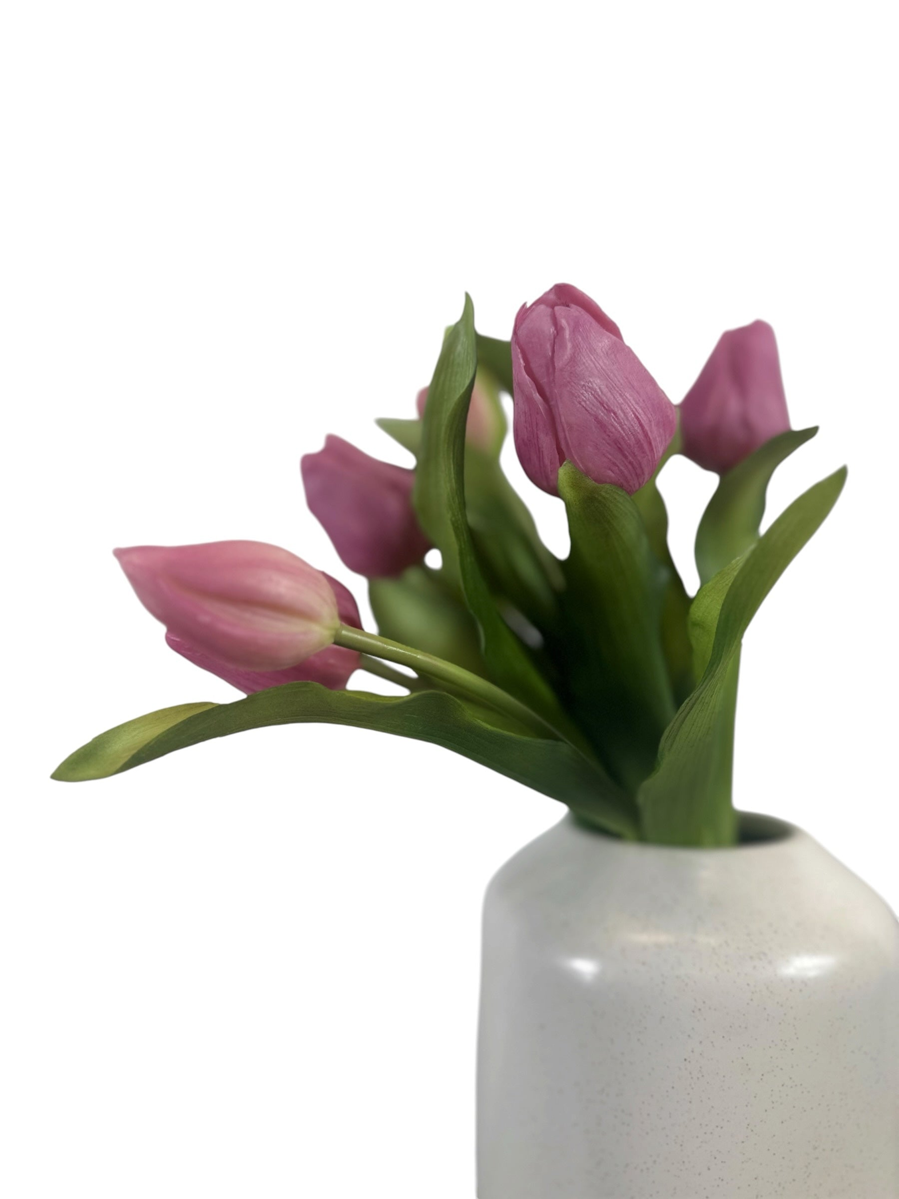 Artificial Bloom bouquet of realistic pink faux tulips with green foliage in a white speckled ceramic vase