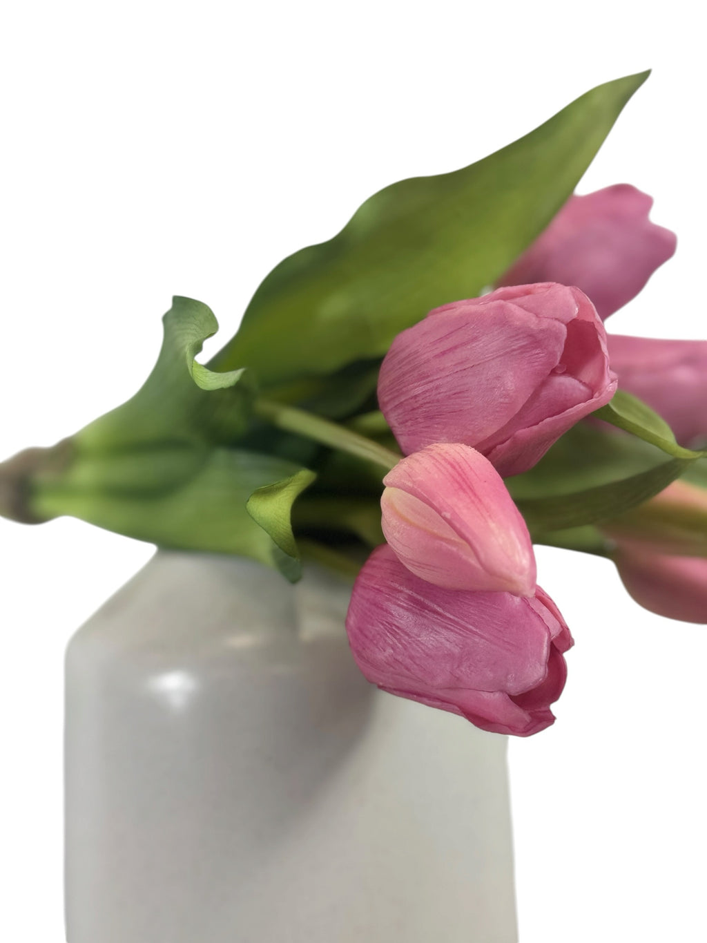 Artificial Bloom bouquet of realistic pink faux tulips with green leaves in a white vase