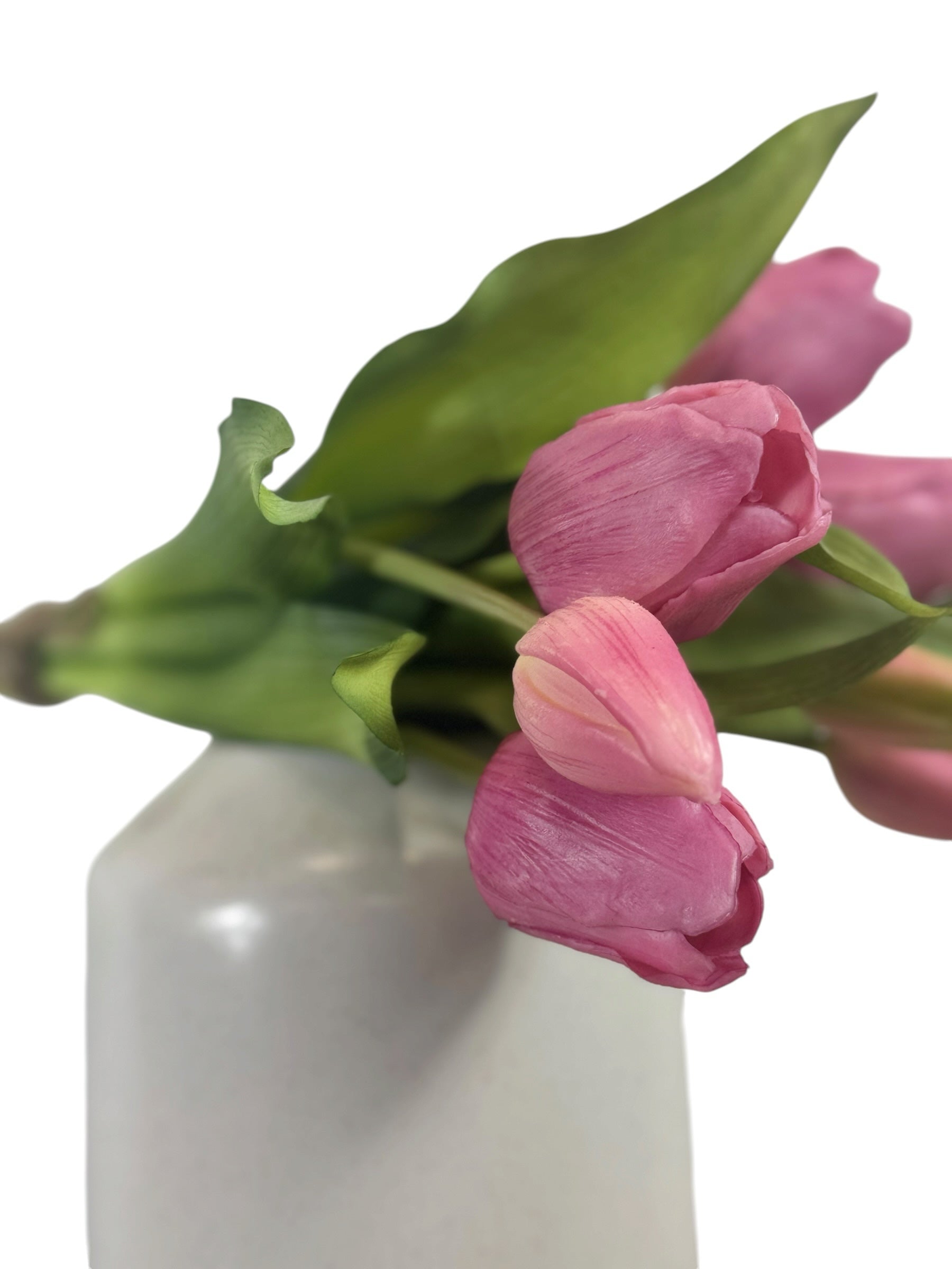 Artificial Bloom bouquet of realistic pink faux tulips with green leaves in a white vase