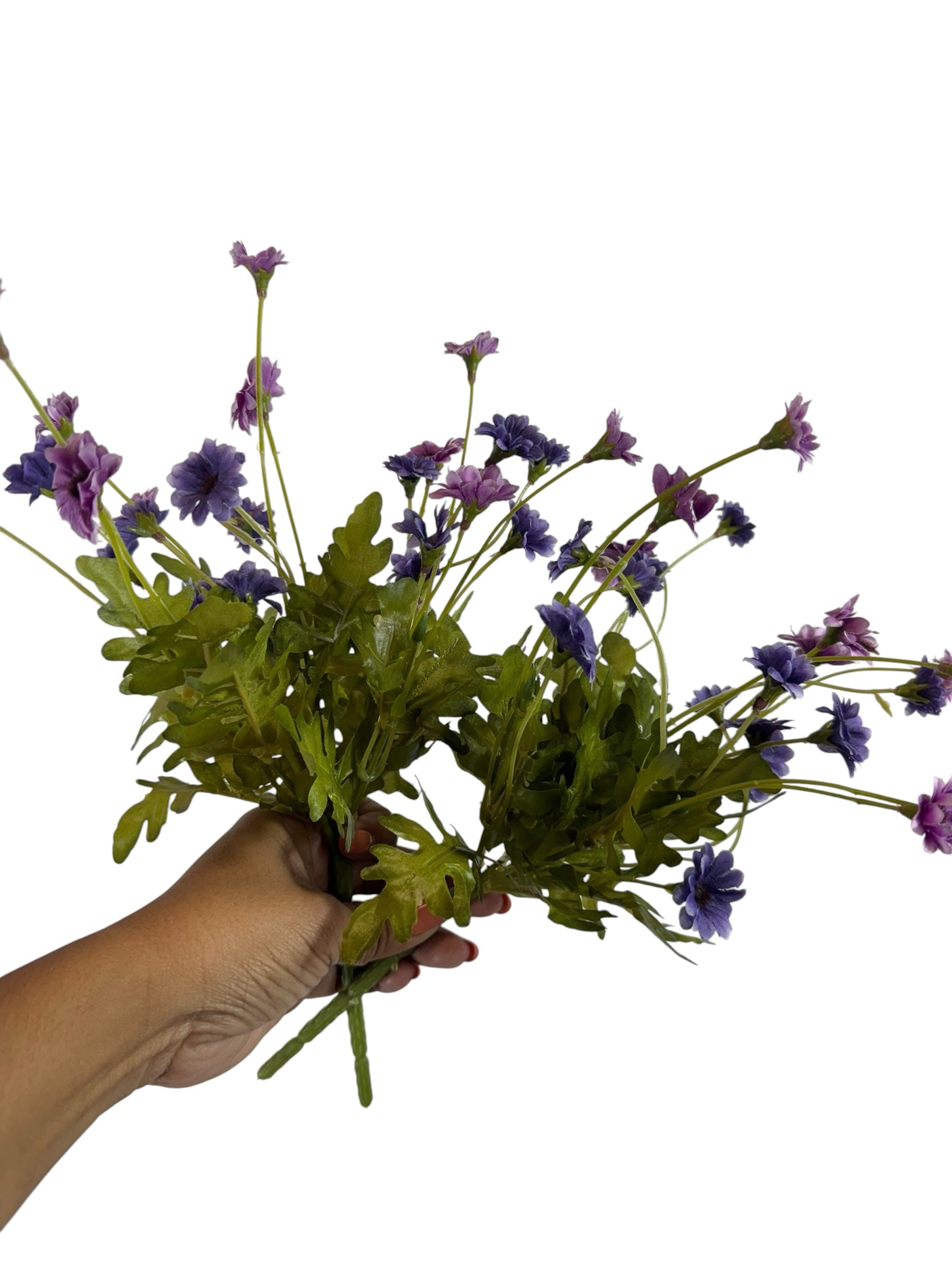 Artificial Bloom purple and lavender fabric daisy bouquet held in a hand against a white background