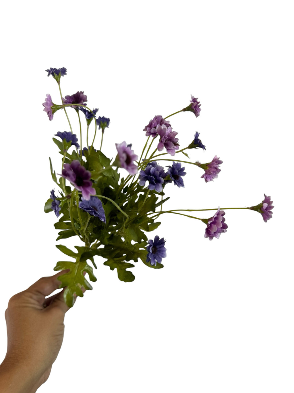 Artificial Bloom purple and lavender fabric daisy bouquet held in hand against a white background