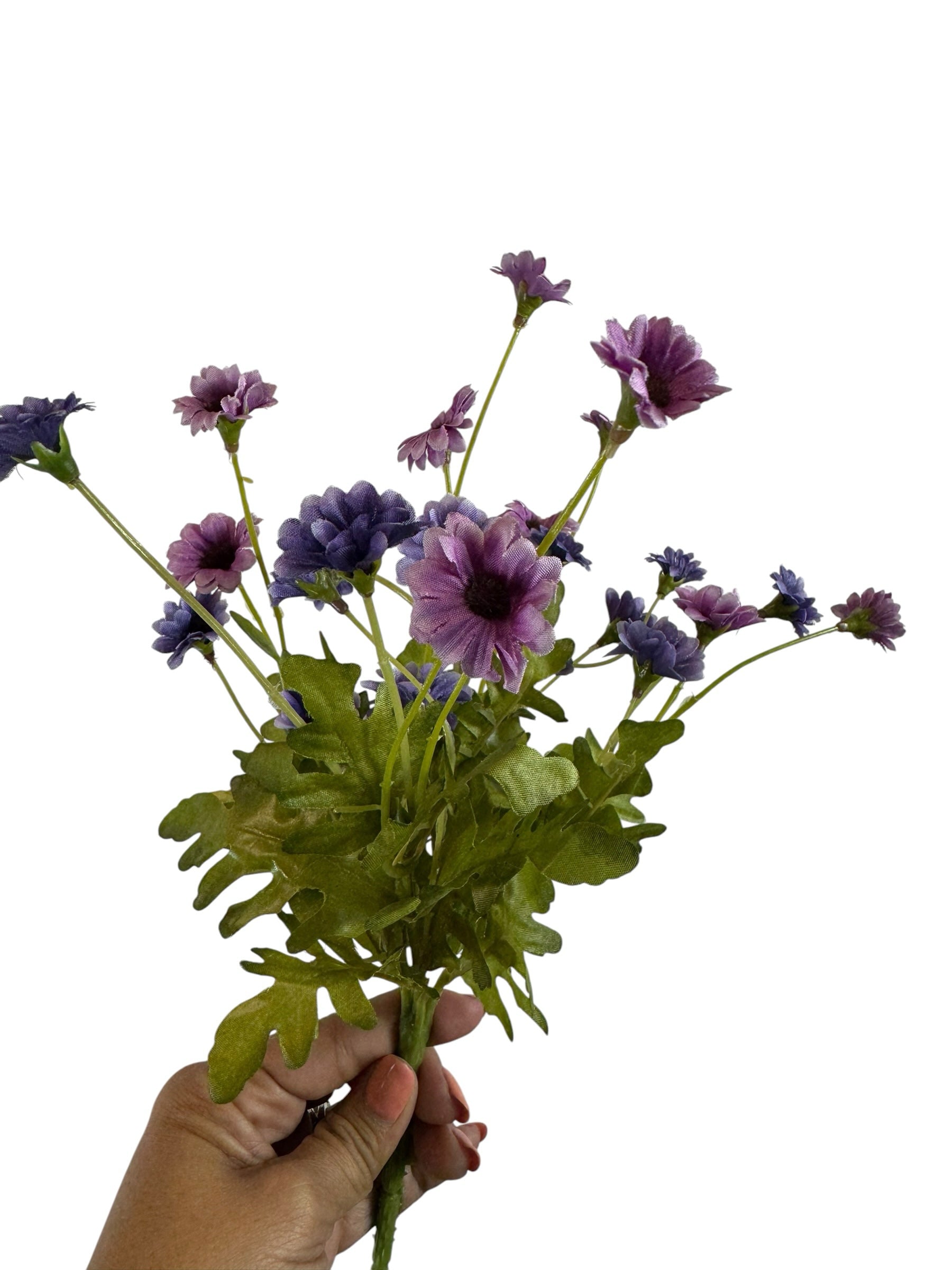 Artificial Bloom purple and lavender fabric daisy bouquet held in hand against a white background