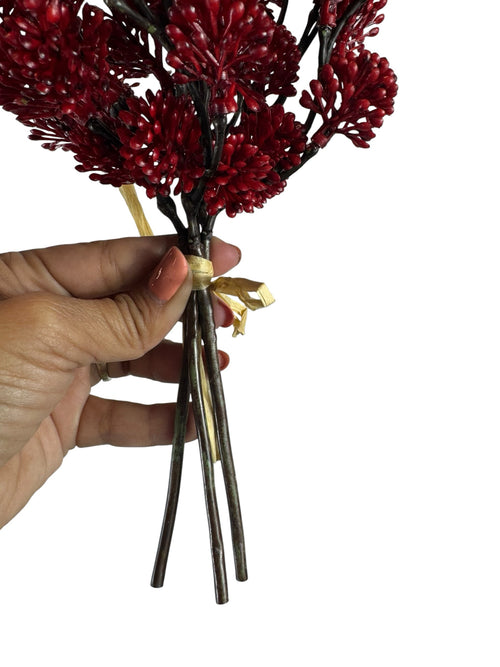 Artificial Bloom red berry branch bundle held in hand, featuring textured faux berries tied with a decorative ribbon.