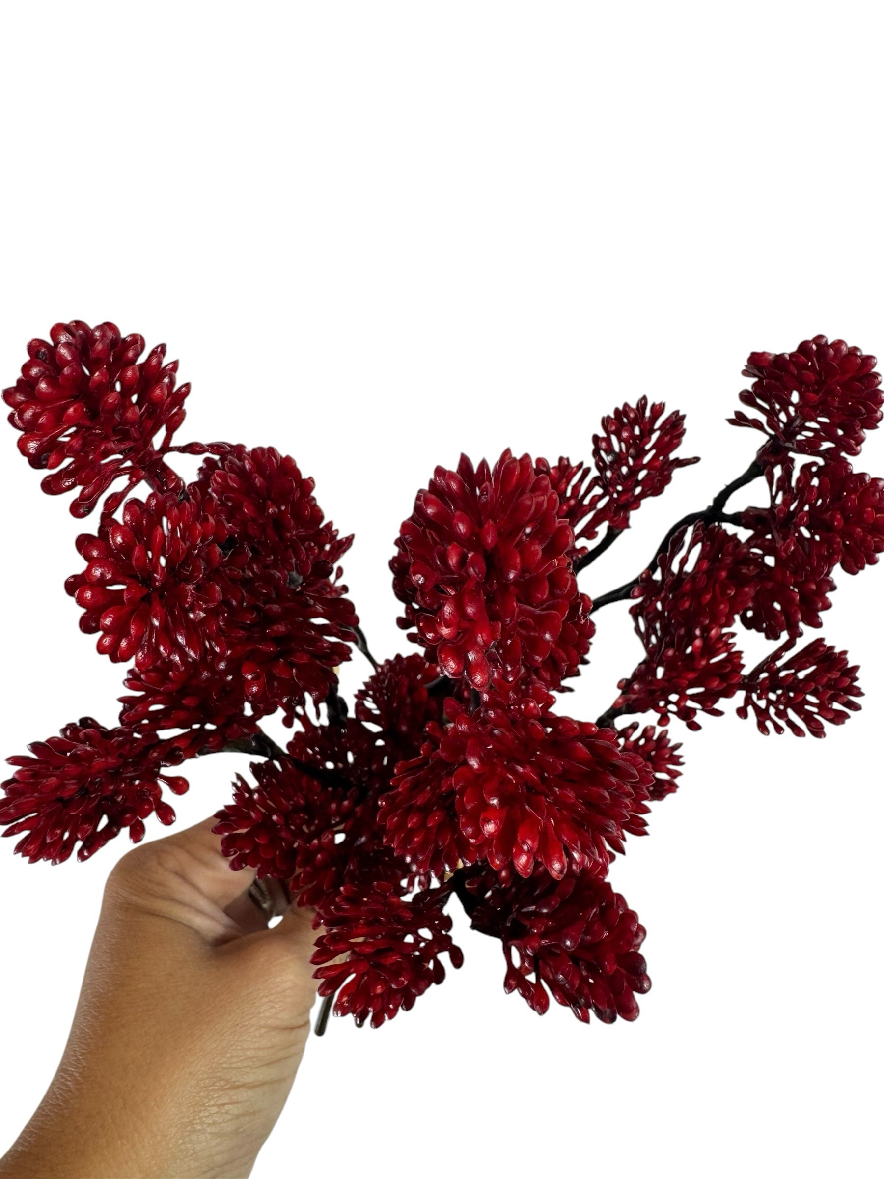 Artificial Bloom red berry branch bundle held in hand, featuring textured faux botanical clusters for seasonal decor.