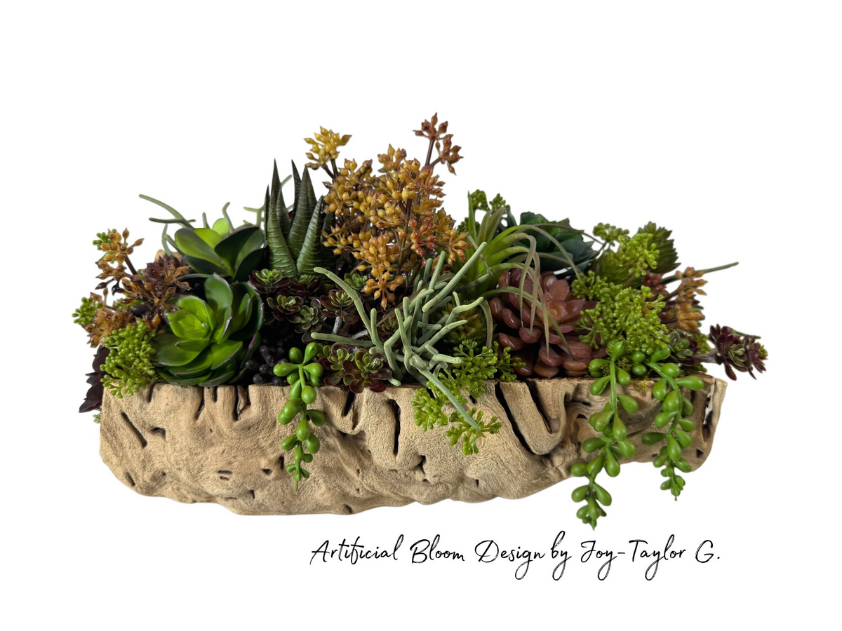 Artificial Bloom succulent arrangement in a textured driftwood-style bowl with green, rust, and sage faux plants.