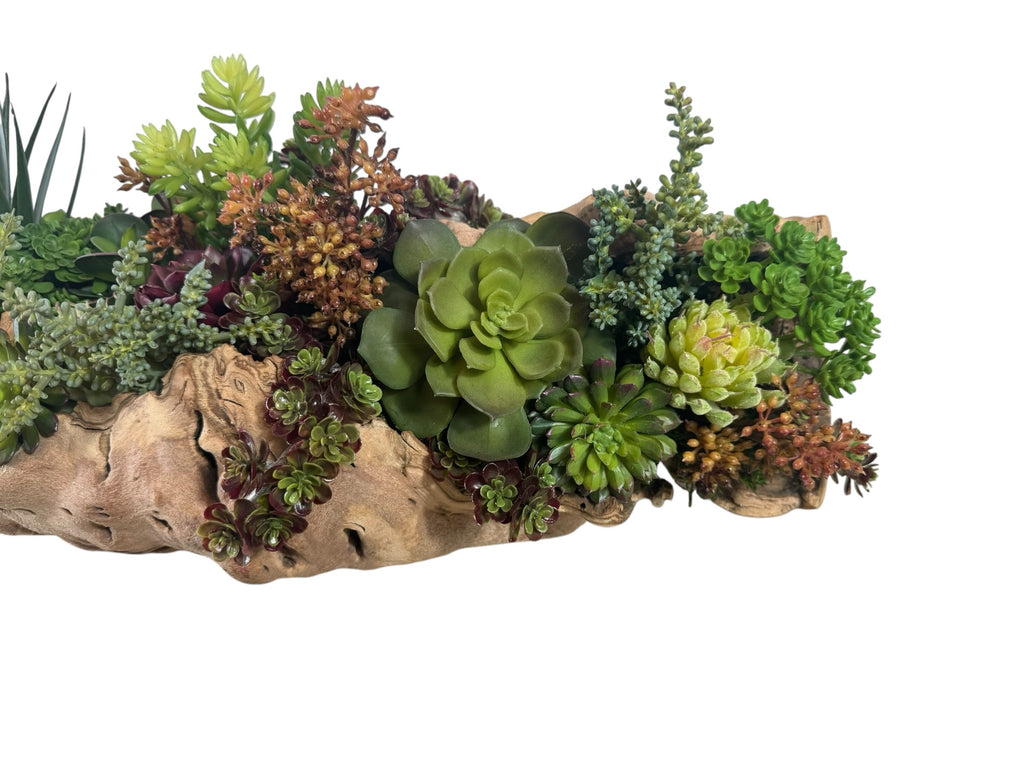 Artificial Bloom succulent arrangement featuring vibrant green and purple plants nestled in a rustic driftwood base.