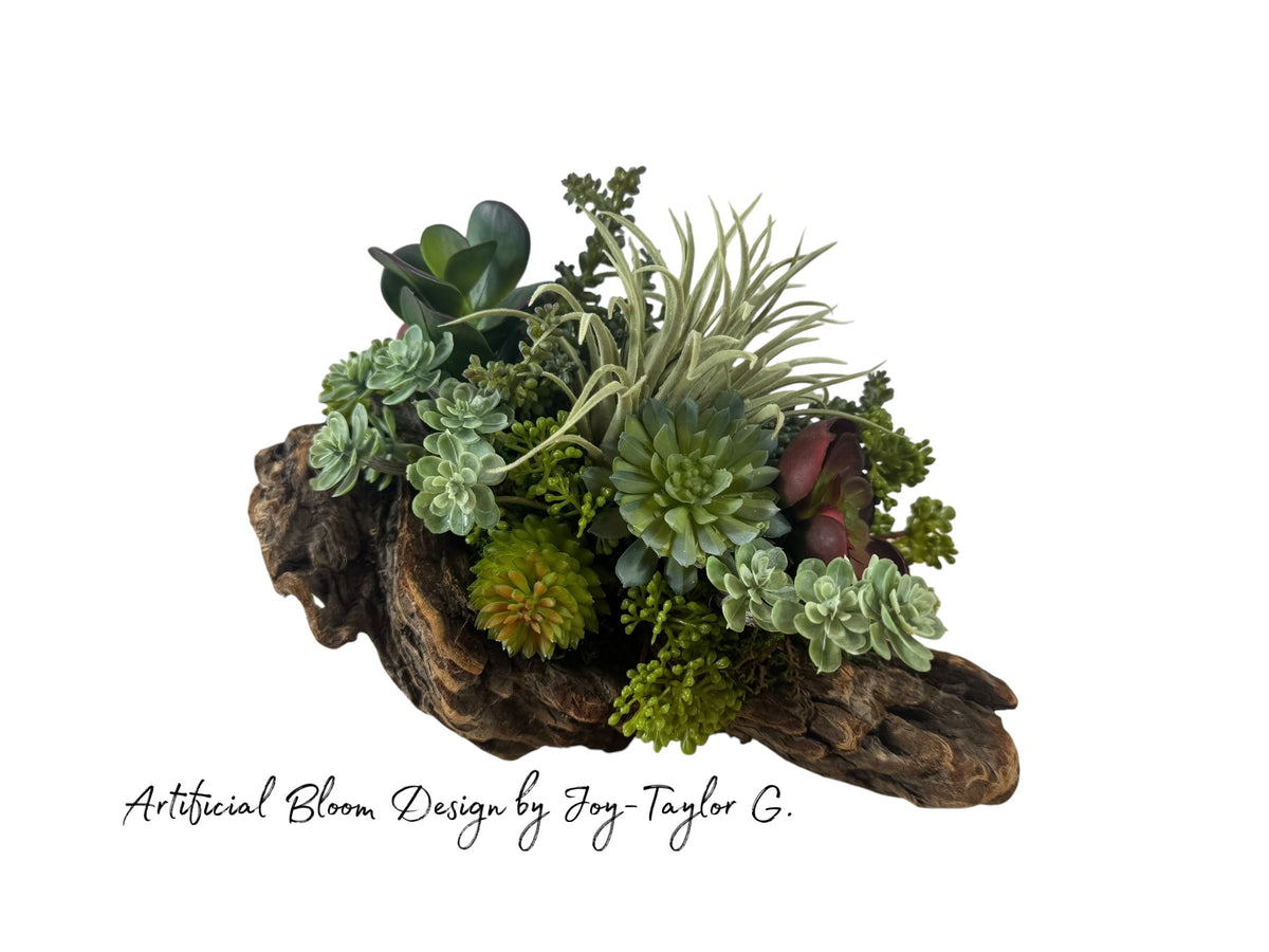Artificial Bloom succulent arrangement featuring burgundy and green faux plants in a rustic natural driftwood base