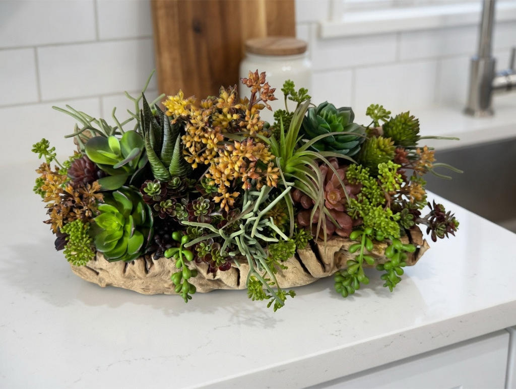 Artificial Bloom succulent arrangement in a textured driftwood-style bowl featuring green, rust, and sage faux plants.