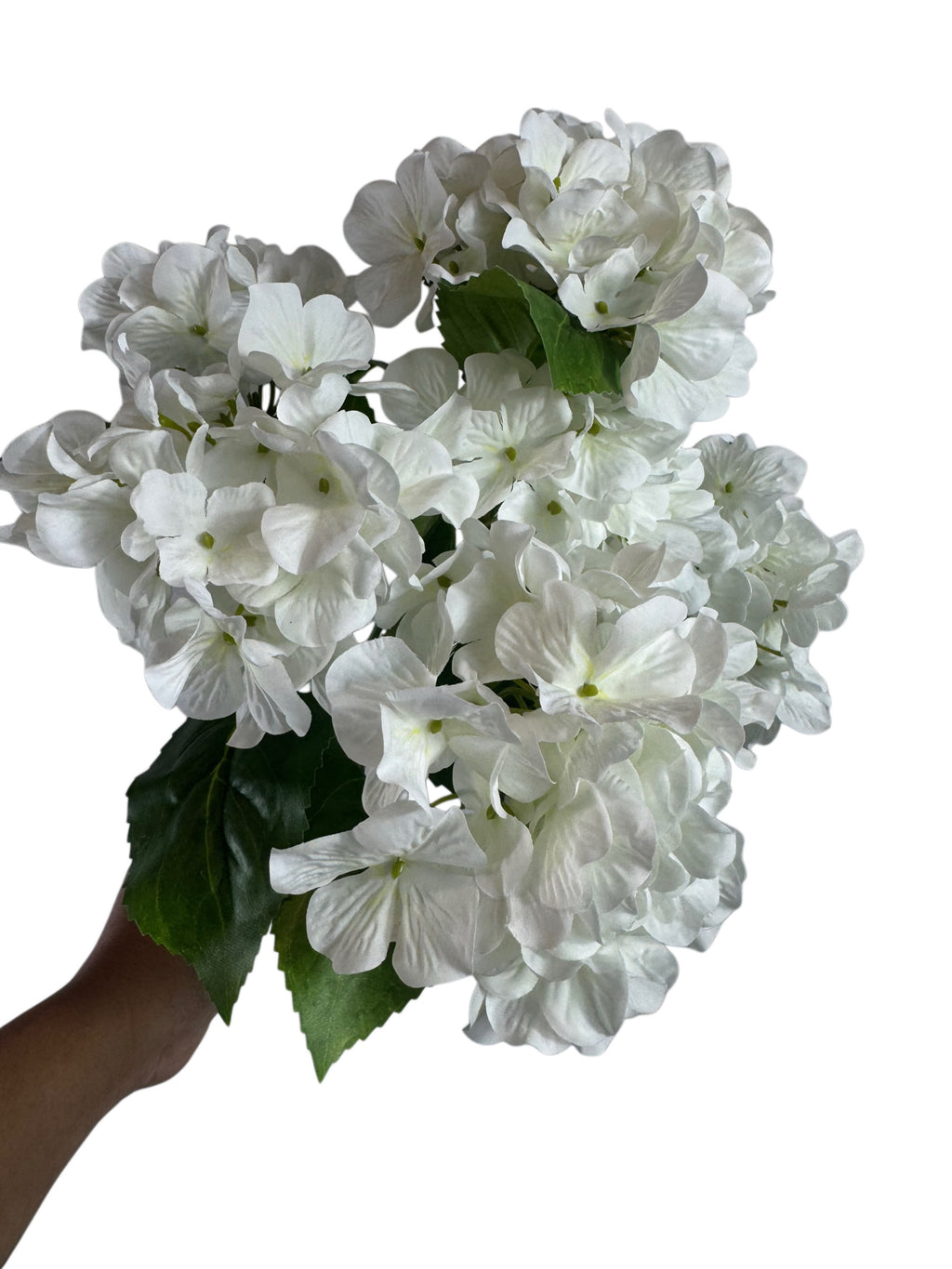 Artificial Bloom white hydrangea bouquet with realistic fabric petals and green leaves held against a white background
