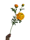 Artificial Bloom decorative ranunculus stem with vibrant yellow and orange petals, green leaves, and flower buds.